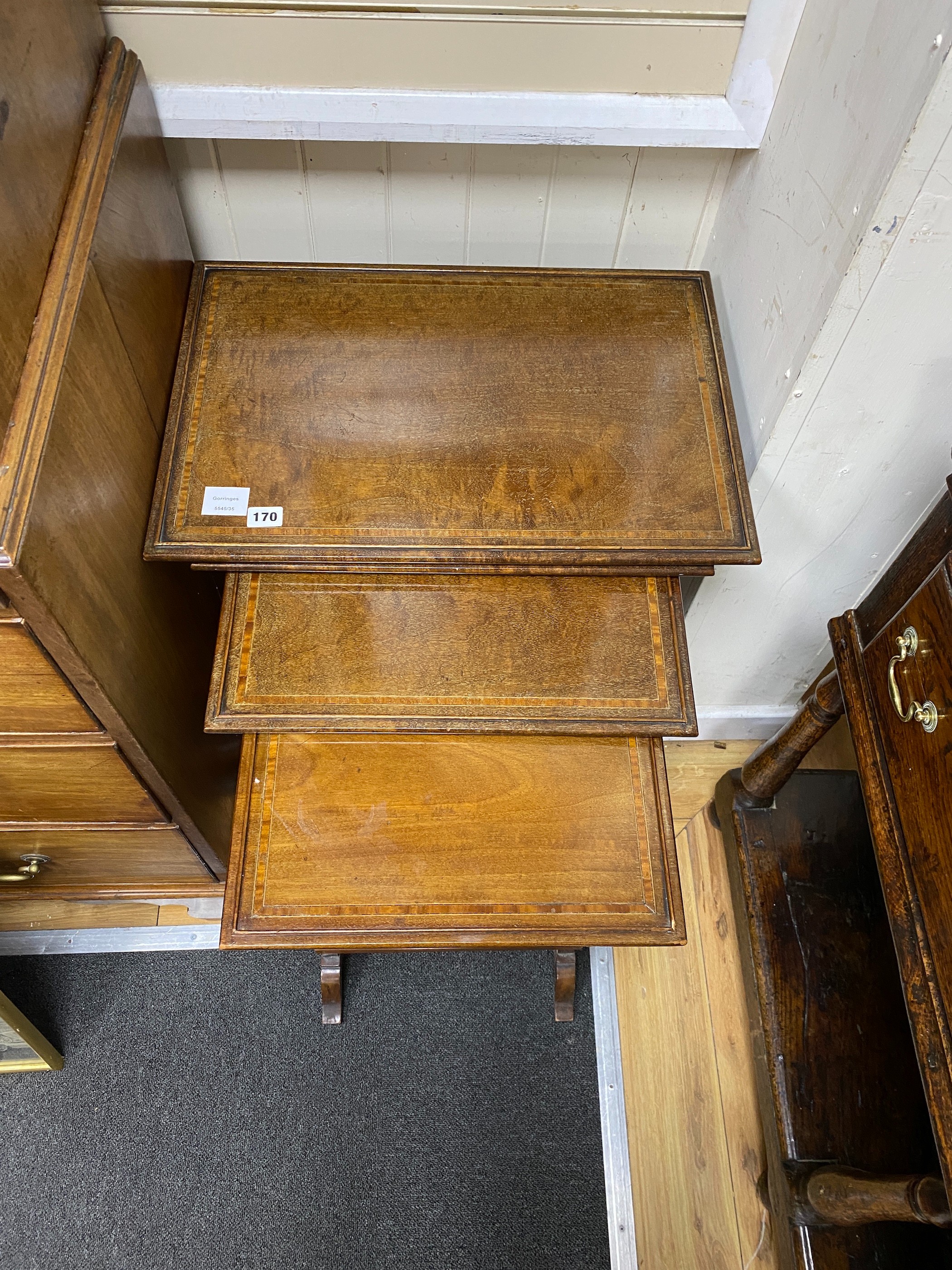 A nest of four Edwardian banded mahogany tea tables, width 55cm, depth 38cm, height 72cm